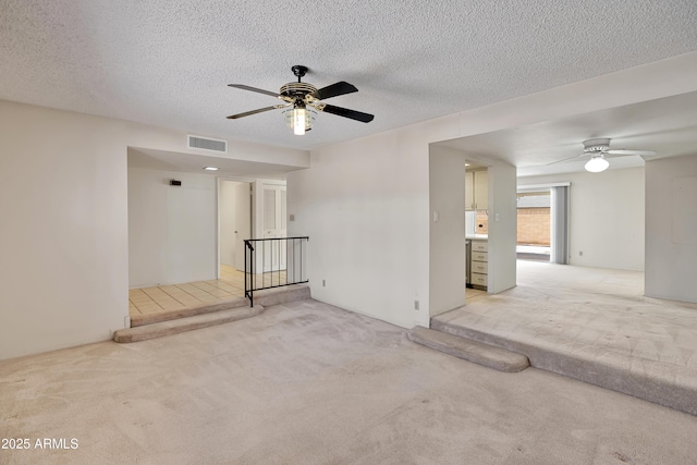 8326 E Valley View Rd, Scottsdale, AZ 85250 - empty room featuring light colored carpet, ceiling fan, and a textured ceiling