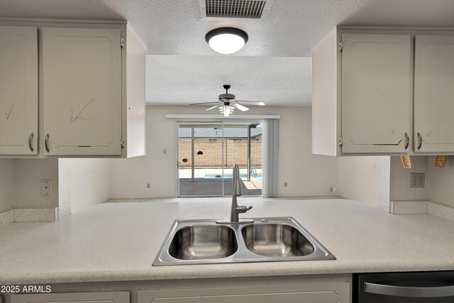 8326 E Valley View Rd, Scottsdale, AZ 85250 - kitchen featuring a sink, stainless steel dishwasher, a textured ceiling, ceiling fan, and light countertops