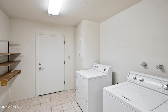 8326 E Valley View Rd, Scottsdale, AZ 85250 - laundry area with independent washer and dryer, light tile patterned flooring, and baseboards