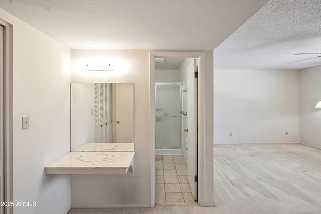 8326 E Valley View Rd, Scottsdale, AZ 85250 - bathroom with a textured ceiling, a shower stall, baseboards, and tile patterned flooring