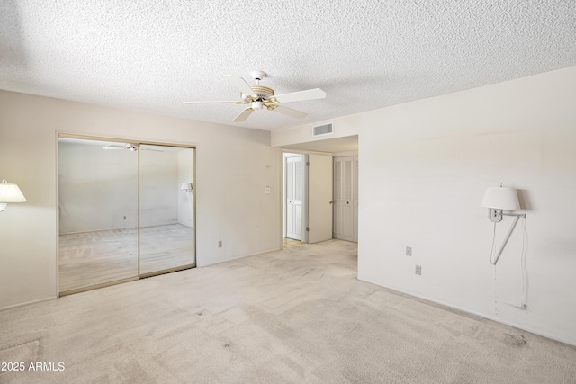 8326 E Valley View Rd, Scottsdale, AZ 85250 - unfurnished bedroom with carpet flooring, a closet, a textured ceiling, and a ceiling fan