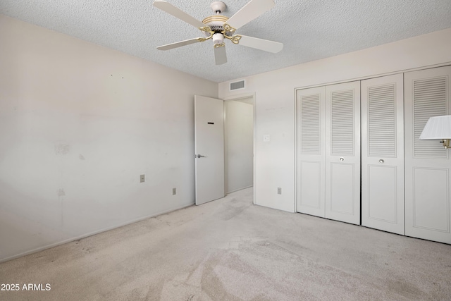 8326 E Valley View Rd, Scottsdale, AZ 85250 - unfurnished bedroom with carpet flooring, a textured ceiling, a closet, and ceiling fan