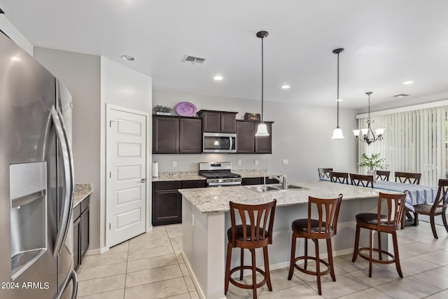 kitchen featuring light tile patterned floors, visible vents, stainless steel appliances, and a sink