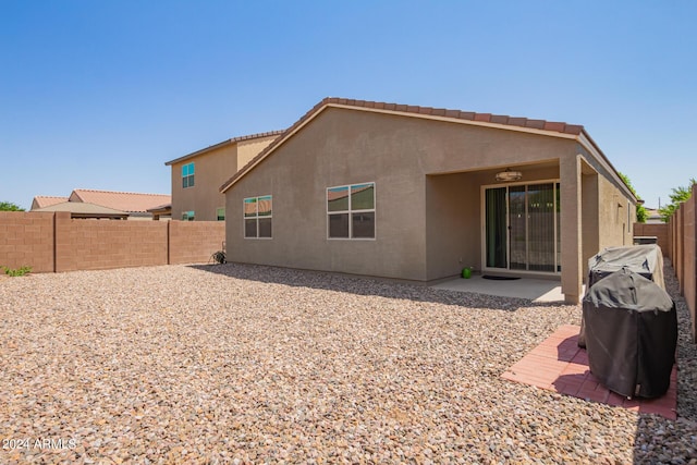 back of house featuring a patio area, a fenced backyard, and stucco siding