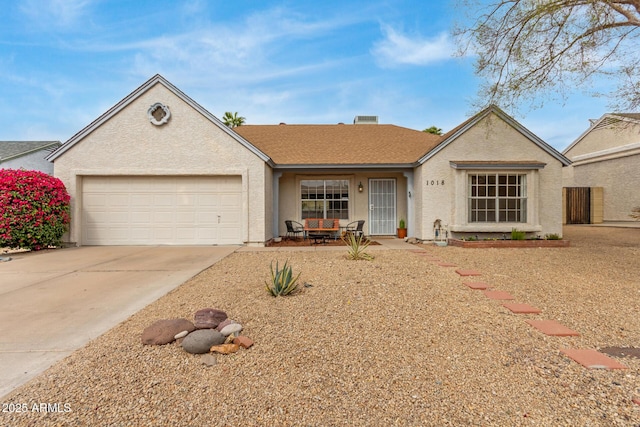 ranch-style home with a garage, a shingled roof, concrete driveway, and stucco siding