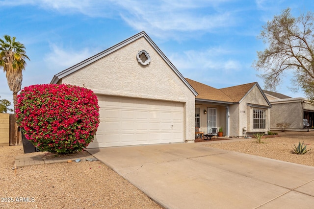 ranch-style house featuring concrete driveway, an attached garage, and stucco siding