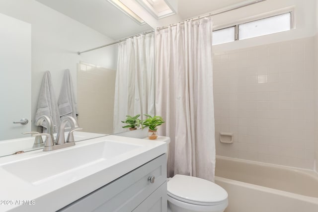 full bathroom with toilet, shower / bathtub combination with curtain, and vanity