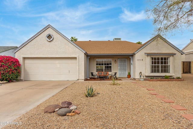 ranch-style home featuring driveway, roof with shingles, a garage, and stucco siding