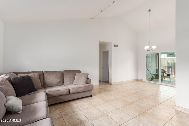 living area featuring an inviting chandelier, baseboards, light tile patterned floors, and visible vents