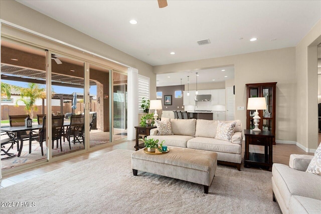 living room with light wood-type flooring and ceiling fan