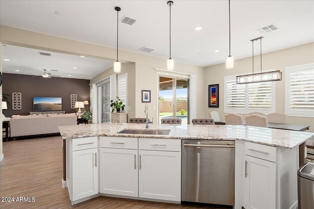 kitchen featuring dishwasher, white cabinets, sink, and decorative light fixtures