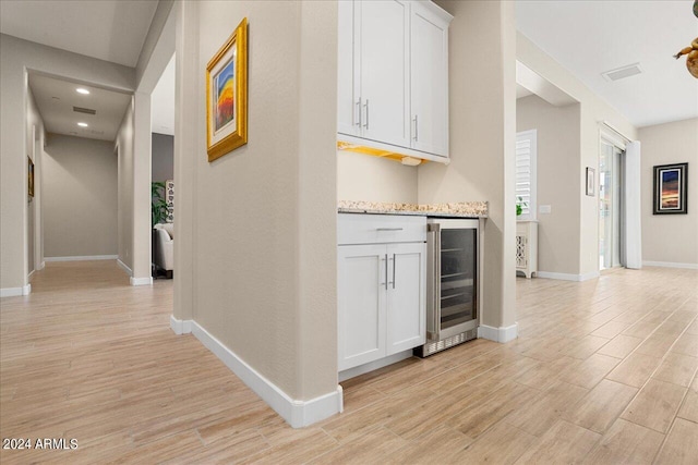 hall with wine cooler and light wood-type flooring