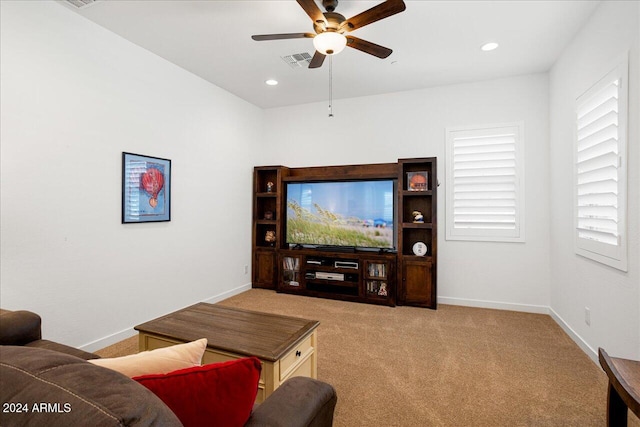 living room featuring light colored carpet and ceiling fan