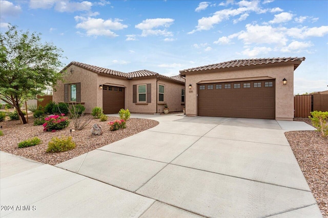 mediterranean / spanish-style house with a garage