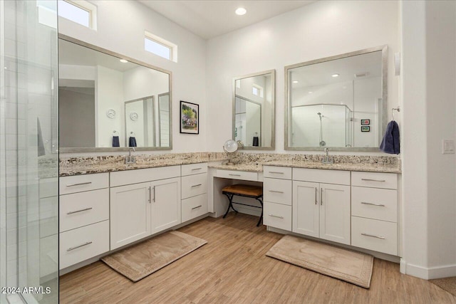 bathroom with vanity, wood-type flooring, and an enclosed shower