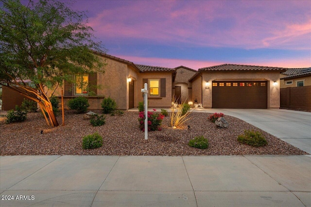 mediterranean / spanish-style home with a garage