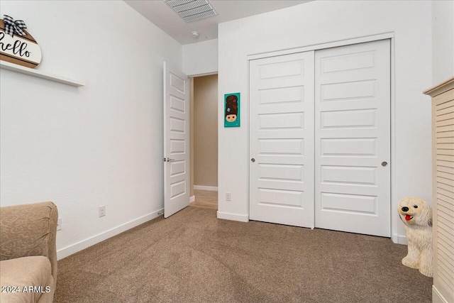 bedroom with carpet and a closet