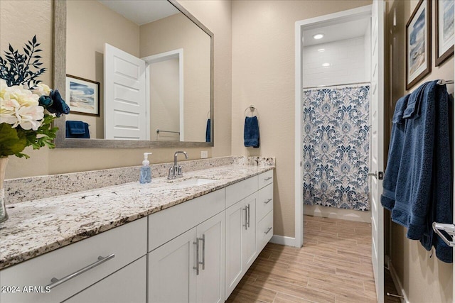 bathroom with vanity, hardwood / wood-style floors, and curtained shower