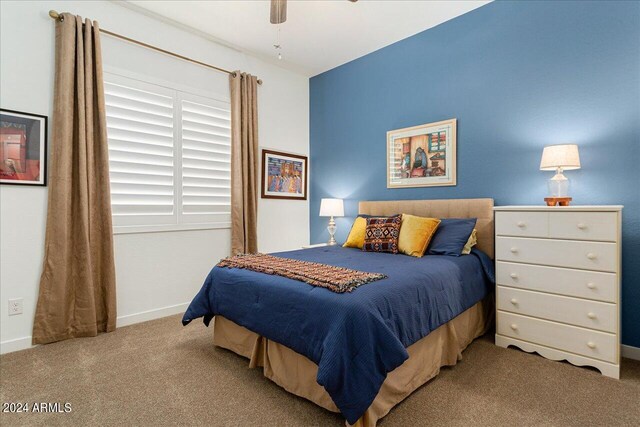 bedroom featuring light carpet and ceiling fan