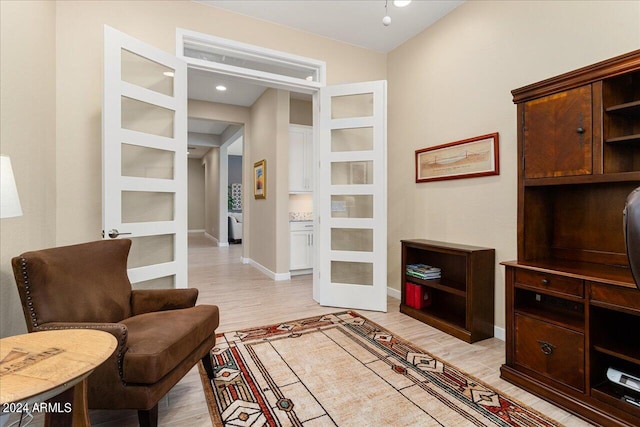 living room featuring french doors and light wood-type flooring