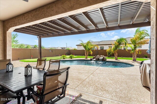 view of swimming pool with a patio and pool water feature