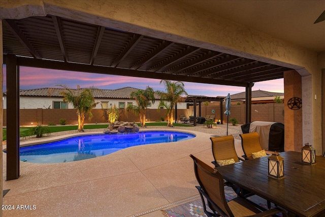 pool at dusk featuring a patio area