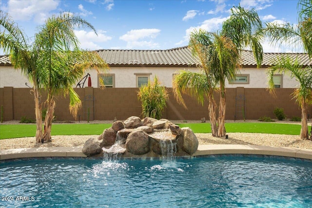 view of pool featuring a yard and pool water feature