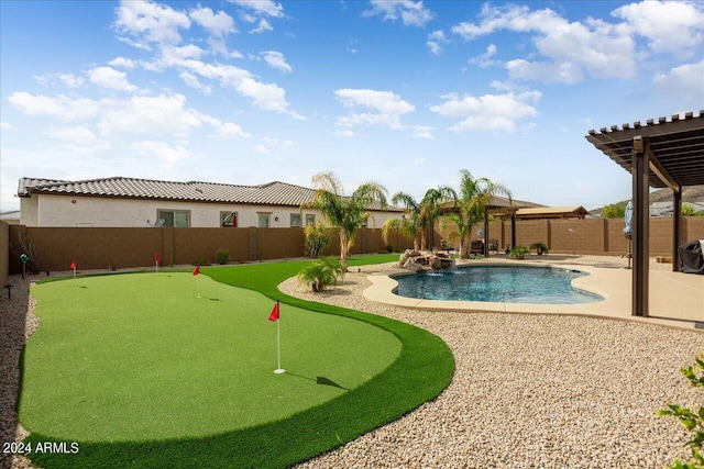 view of swimming pool with pool water feature, a patio area, and a pergola