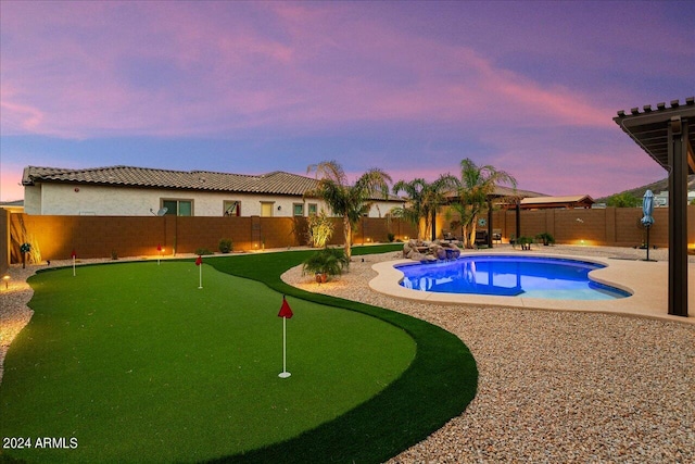 pool at dusk featuring a patio area