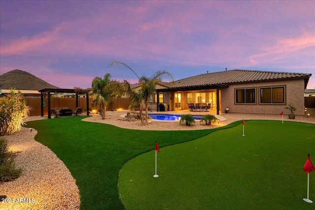 pool at dusk featuring a patio area