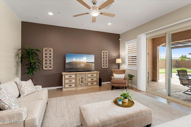 living room featuring wood-type flooring and ceiling fan