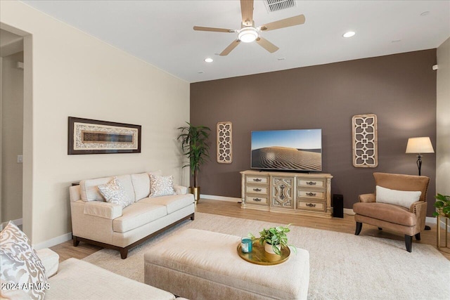 living room with ceiling fan and wood-type flooring