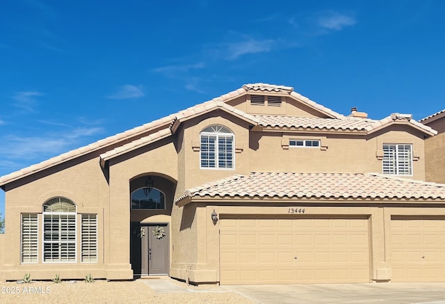 13444 N 13th St, Phoenix, AZ 85022 - mediterranean / spanish-style home with a tile roof, an attached garage, driveway, and stucco siding