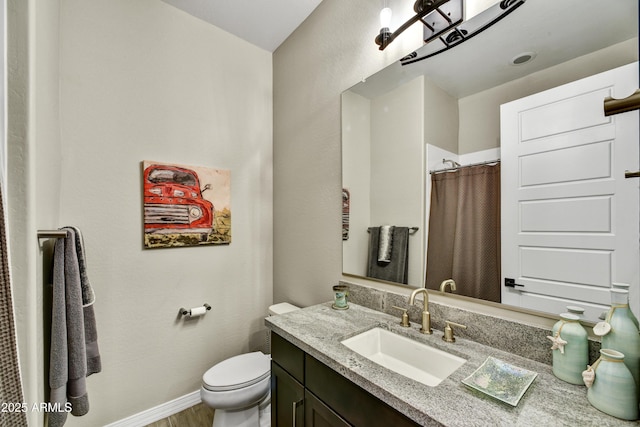 full bathroom with toilet, vanity, wood finished floors, a shower with curtain, and baseboards