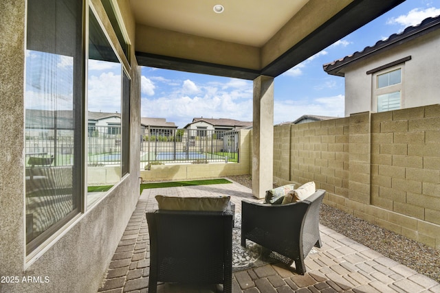 view of patio / terrace featuring fence and a residential view