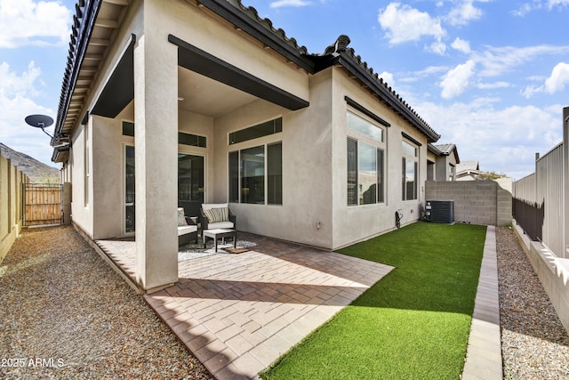 rear view of property featuring central AC unit, a fenced backyard, a tile roof, stucco siding, and a patio area