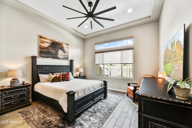 bedroom featuring a ceiling fan, wood finish floors, baseboards, and recessed lighting