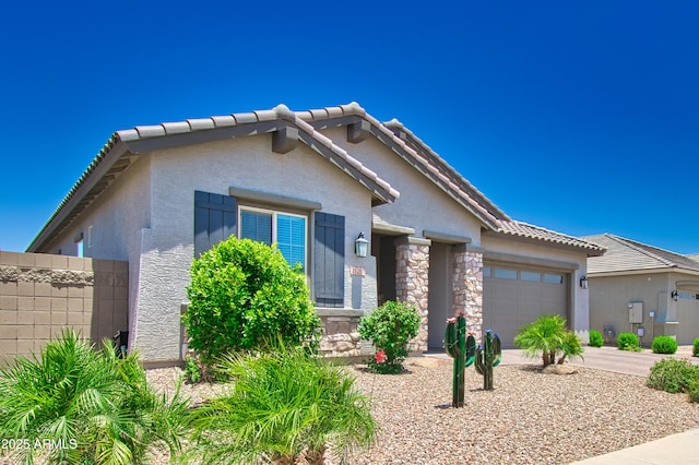 view of front of home with an attached garage, stone siding, concrete driveway, a tiled roof, and stucco siding