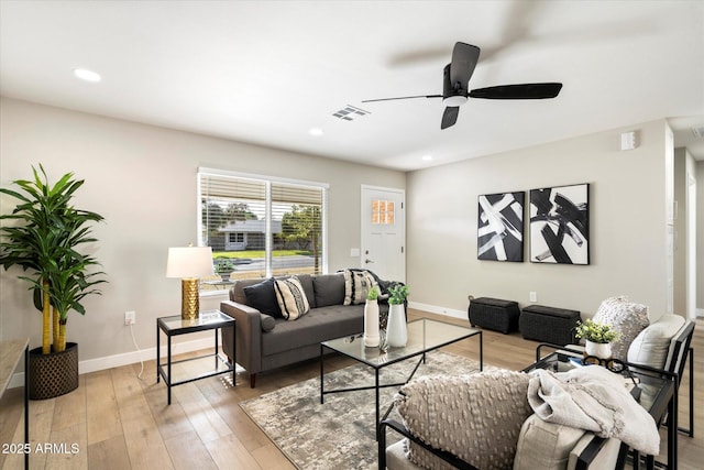 living room with ceiling fan and light hardwood / wood-style floors