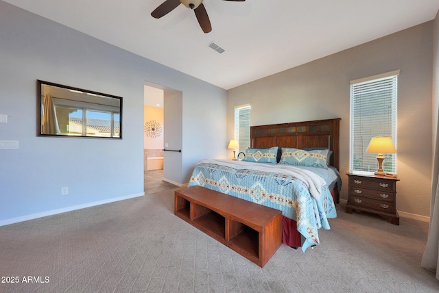 bedroom featuring visible vents, vaulted ceiling, light carpet, and baseboards