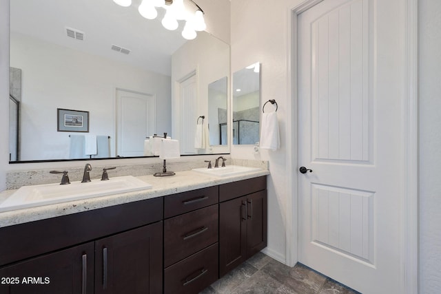 full bathroom featuring double vanity, visible vents, and a sink