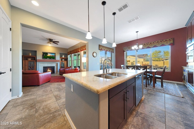 kitchen featuring appliances with stainless steel finishes, a sink, visible vents, and pendant lighting