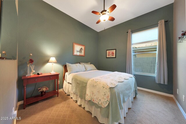 bedroom with a ceiling fan, lofted ceiling, and baseboards