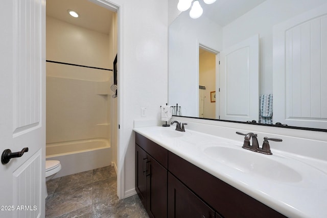 bathroom featuring double vanity, toilet, shower / washtub combination, and a sink