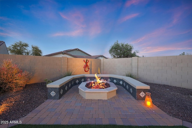 view of patio featuring an outdoor fire pit and a fenced backyard