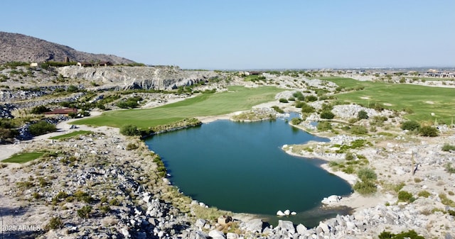 aerial view with view of golf course and a water and mountain view