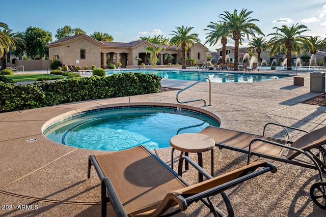 view of pool featuring a patio area and a hot tub