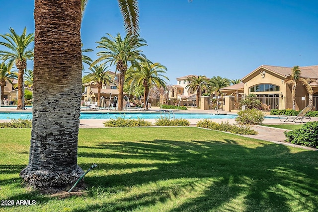 view of pool featuring a lawn