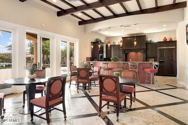 dining area with beam ceiling