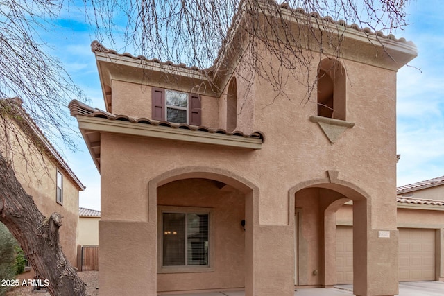 view of front of house featuring a tiled roof and stucco siding